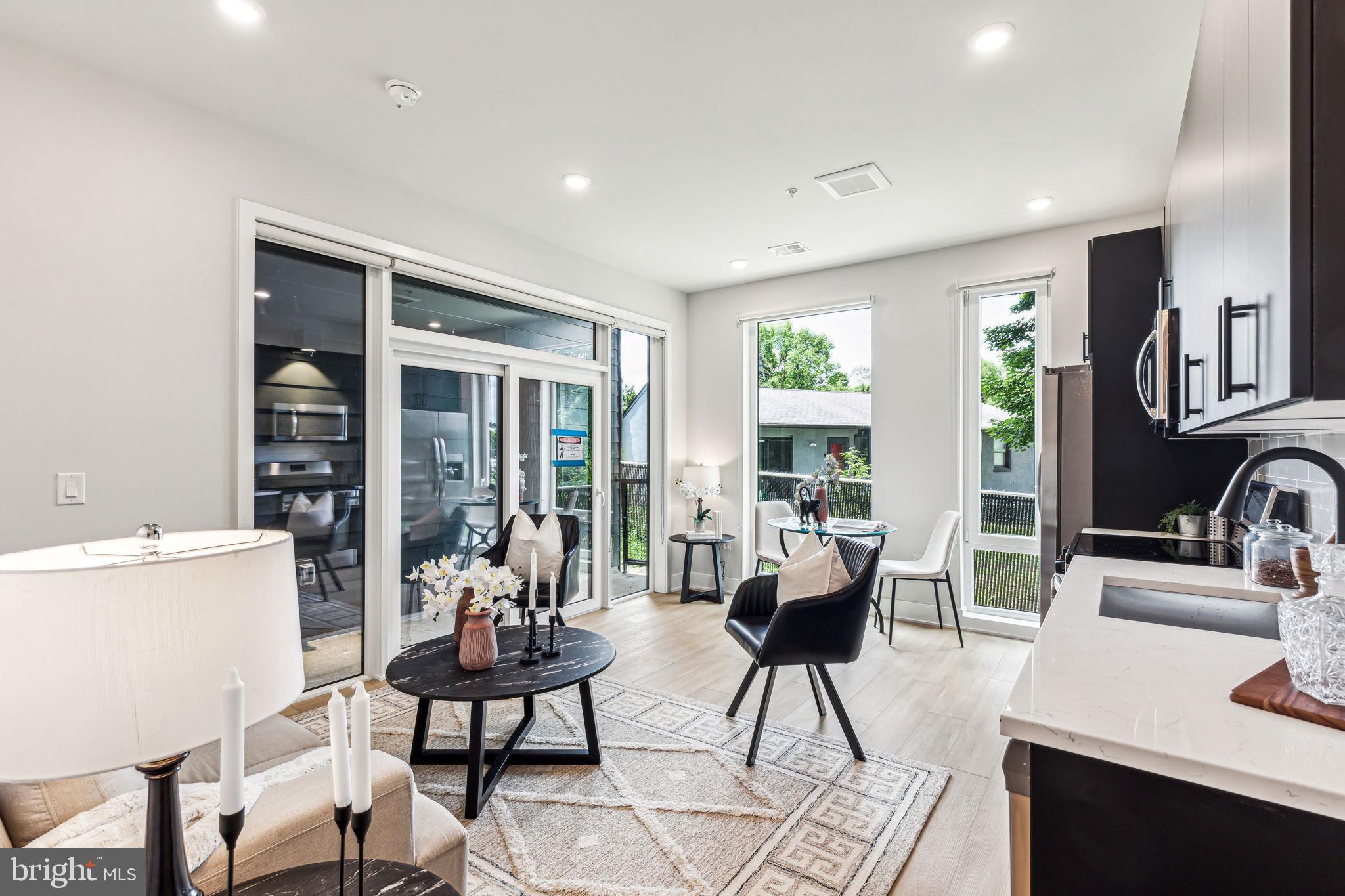 6910 Ridge Avenue, Unit 409 Philadelphia, PA 19128 - Photo 2 of 15 a living room with furniture and a large window