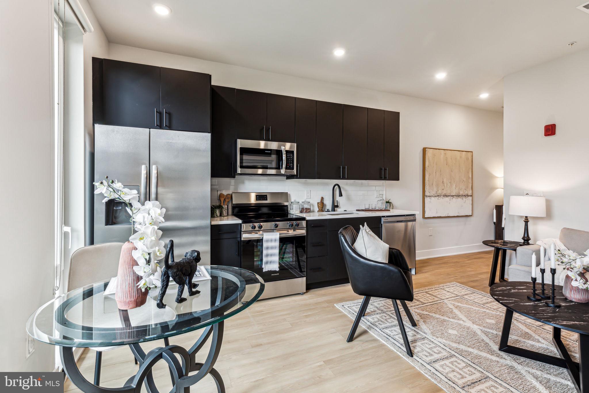 6910 Ridge Avenue, Unit 409 Philadelphia, PA 19128 - Photo 7 of 15 a kitchen with a dining table and chairs