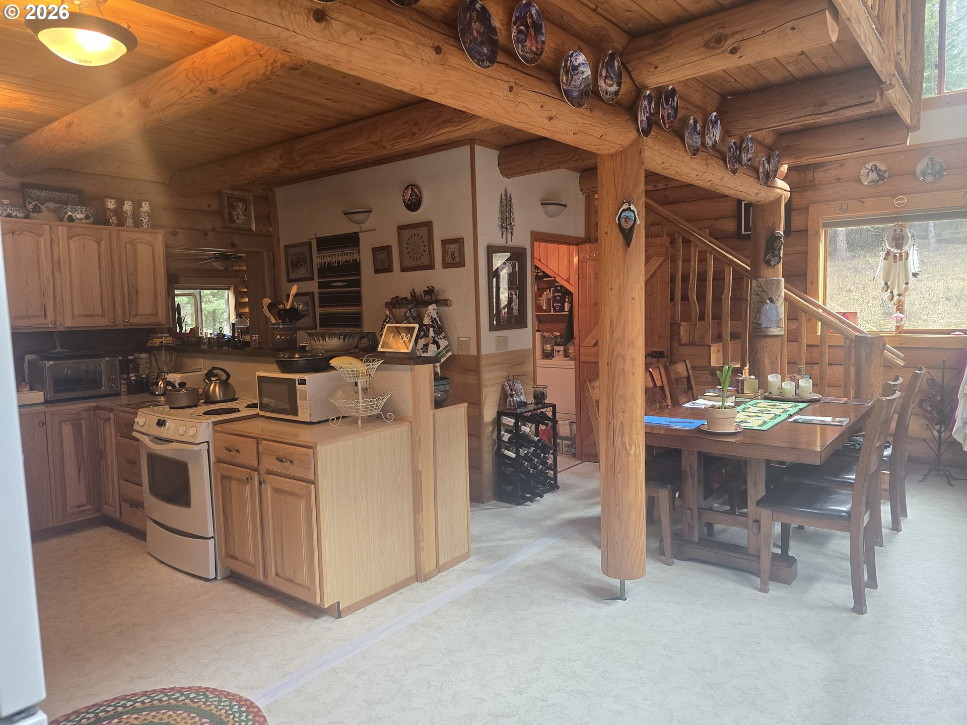 64276 Tamarack Road Lostine, OR 97857 - Photo 13 of 23 a kitchen with stainless steel appliances kitchen island a table and chairs in it