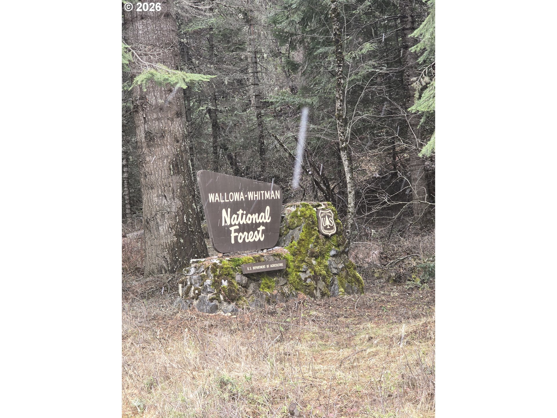 64276 Tamarack Road Lostine, OR 97857 - Photo 20 of 23 a sign that is sitting on a brick wall
