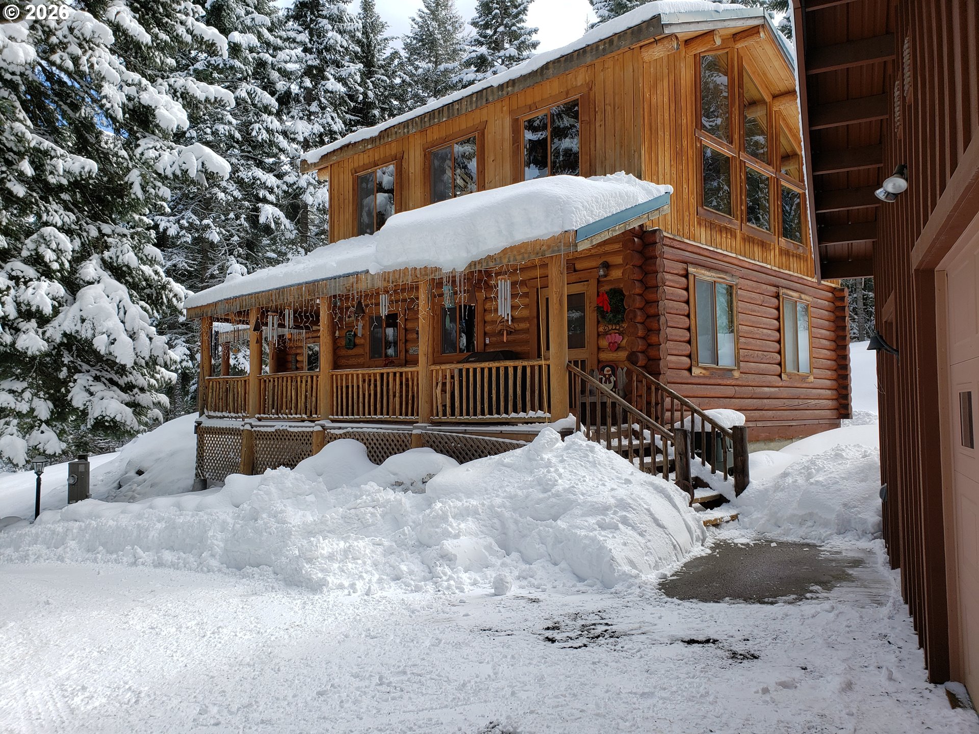 64276 Tamarack Road Lostine, OR 97857 - Photo 5 of 23 a view of a house with a yard covered in snow