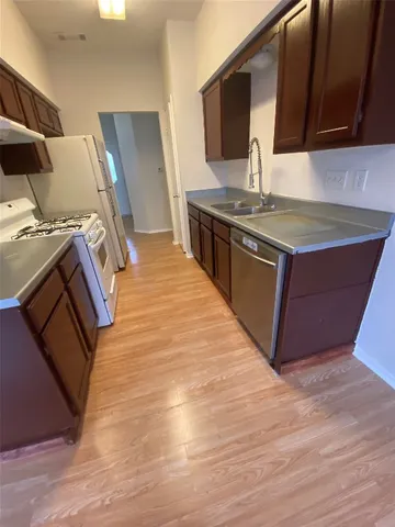 a kitchen with stainless steel appliances granite countertop a stove and a sink