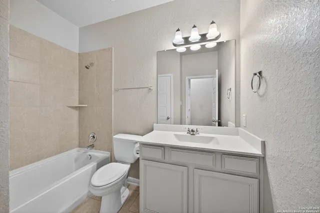 a bathroom with a double vanity sink mirror and toilet