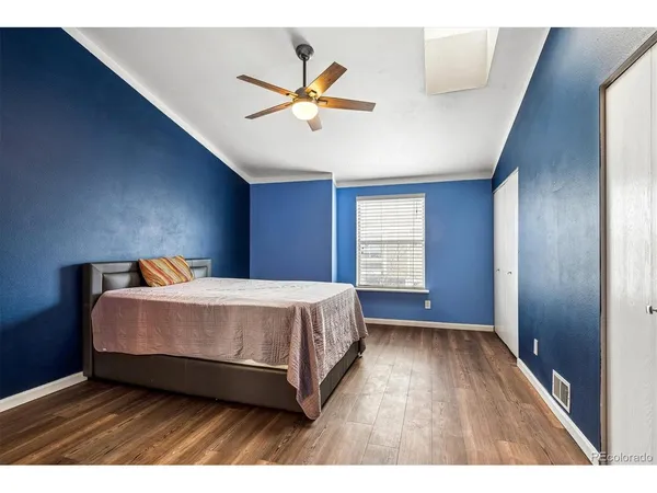 a spacious bedroom with a bed and window