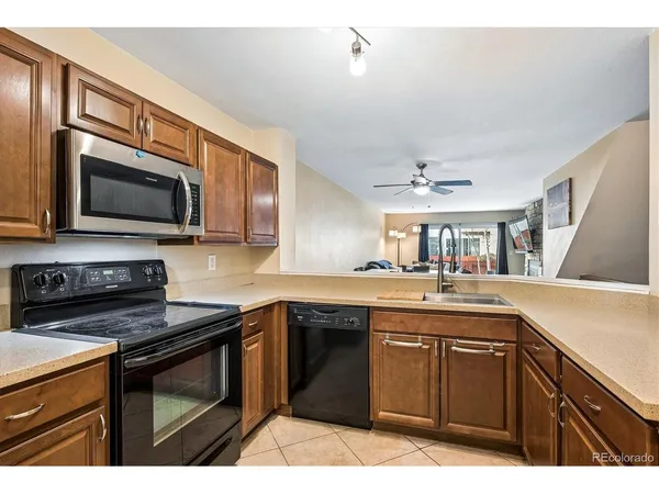 a kitchen with a sink stove and microwave
