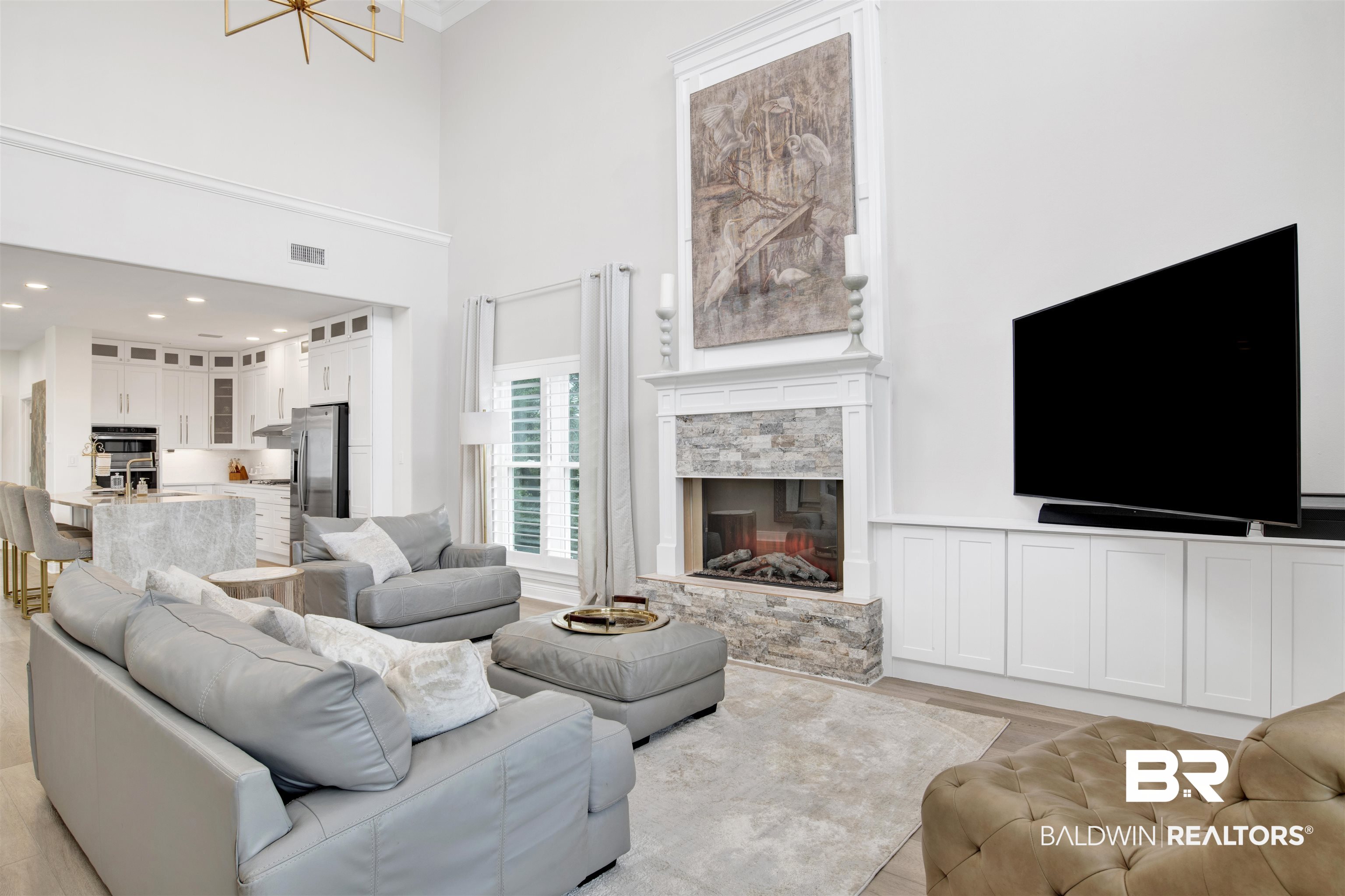 30351 River Road Orange Beach, AL 36561 - Photo 14 of 44 Living area featuring a stone-clad fireplace, high ceilings, and recessed lighting