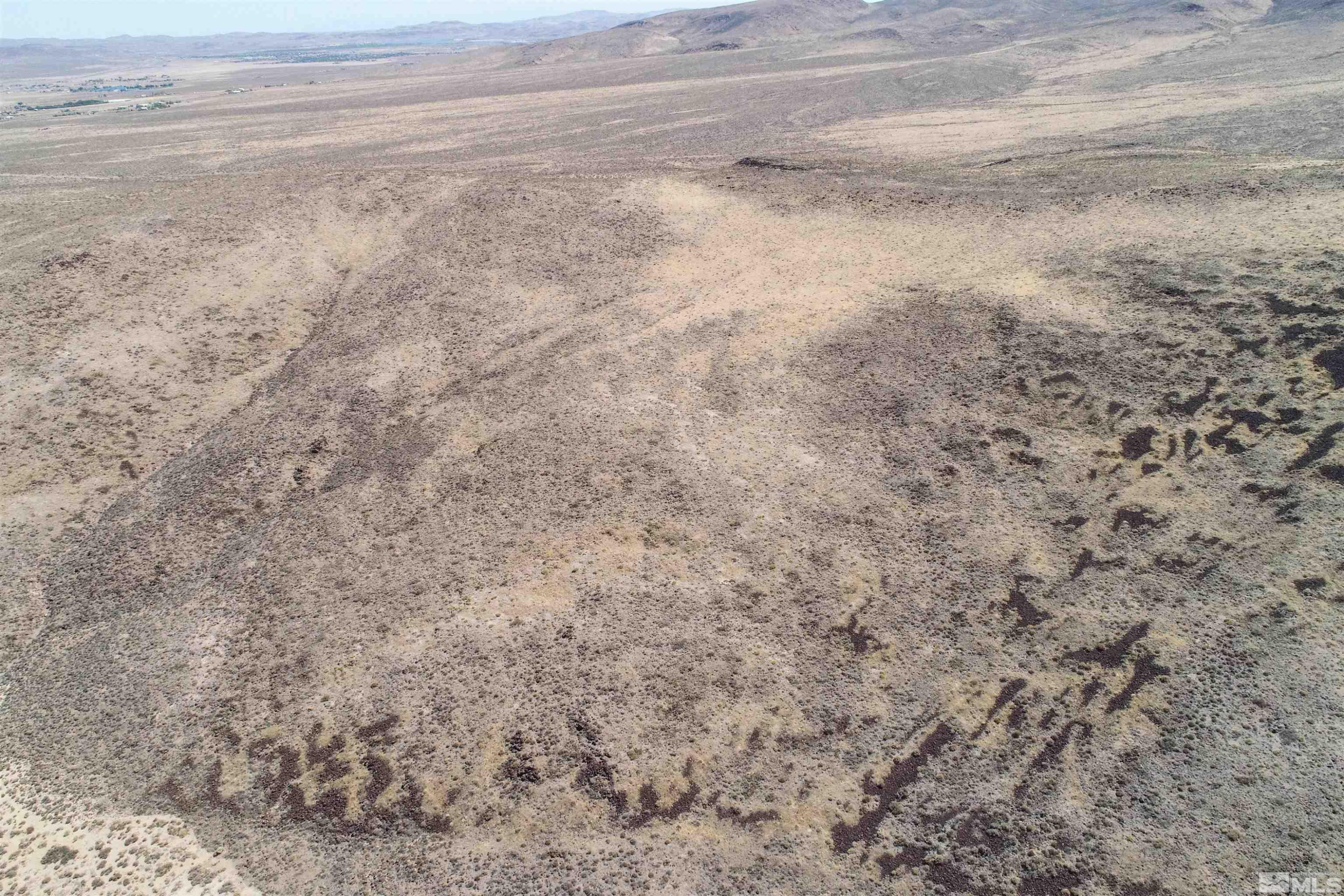 1000 Micro Way Silver Springs, NV 89429 - Photo 2 of 15 a view of a dry yard with wooden floor