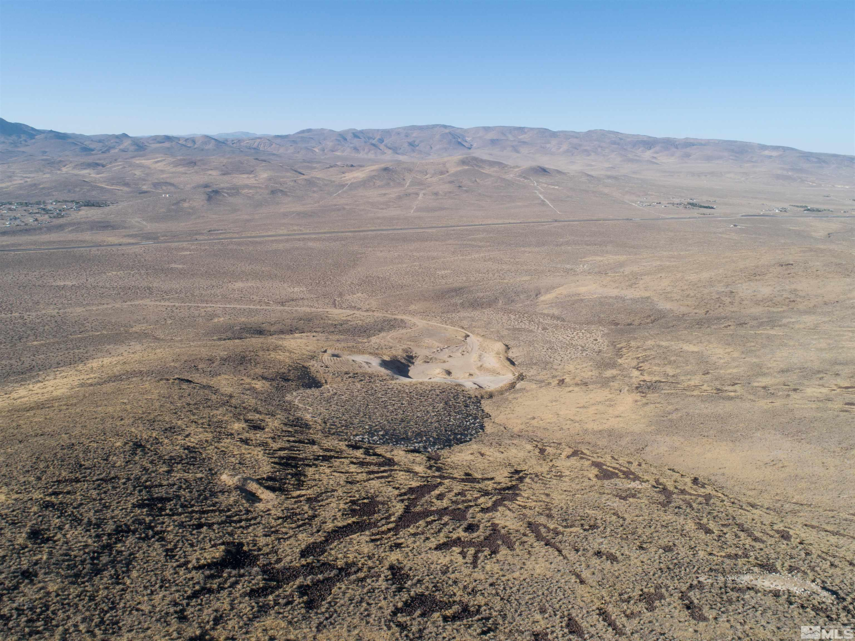1000 Micro Way Silver Springs, NV 89429 - Photo 6 of 15 a view of a dry field with mountains in the background