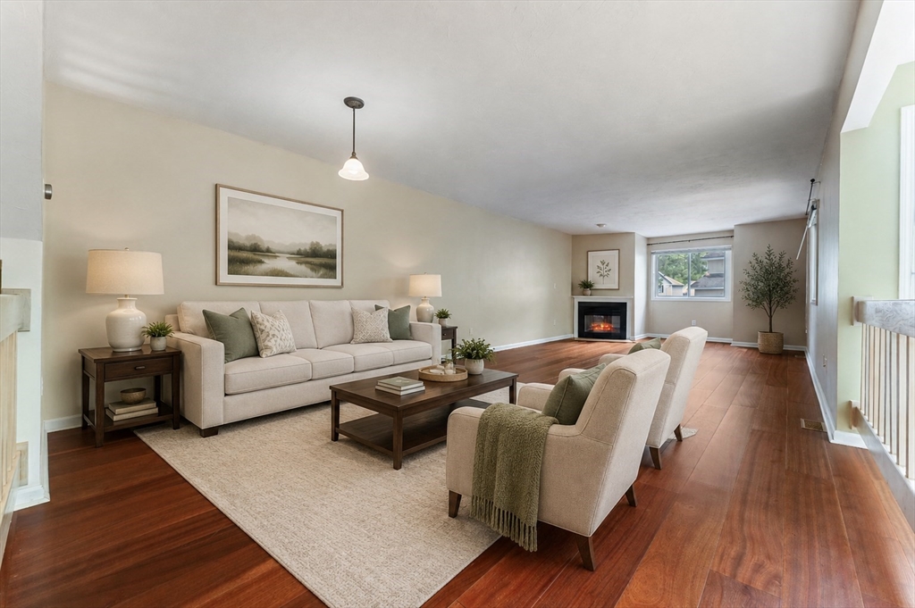 22 Arrowhead Circle, Unit 22 Ashland, MA 01721 - Photo 4 of 35 a living room with furniture and a wooden floor