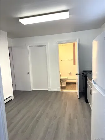 a kitchen with a sink a refrigerator a window and a dresser