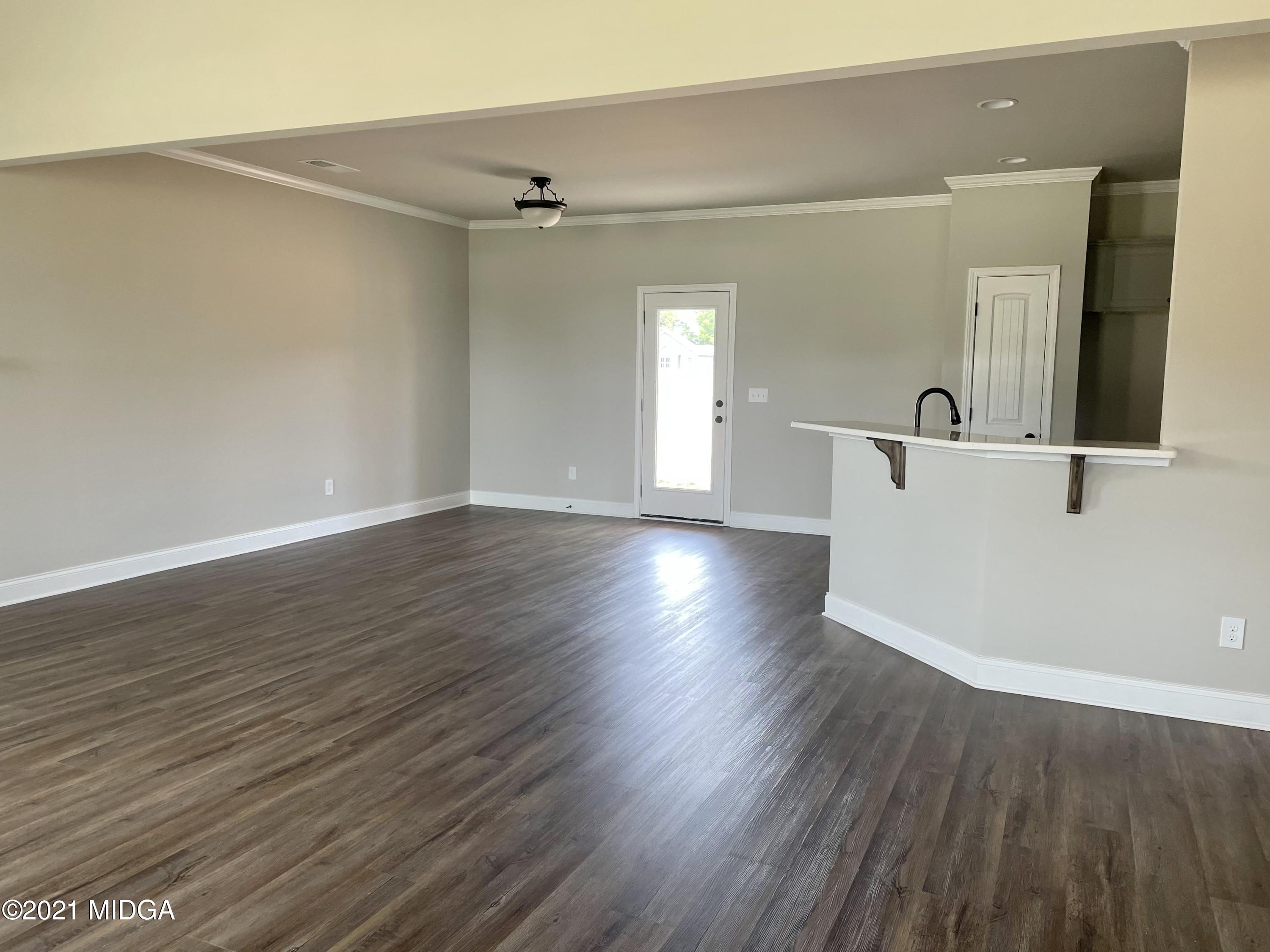 1452 Bunn Road Forsyth, GA 31029 - Photo 3 of 9 a view of a big room with wooden floor and windows