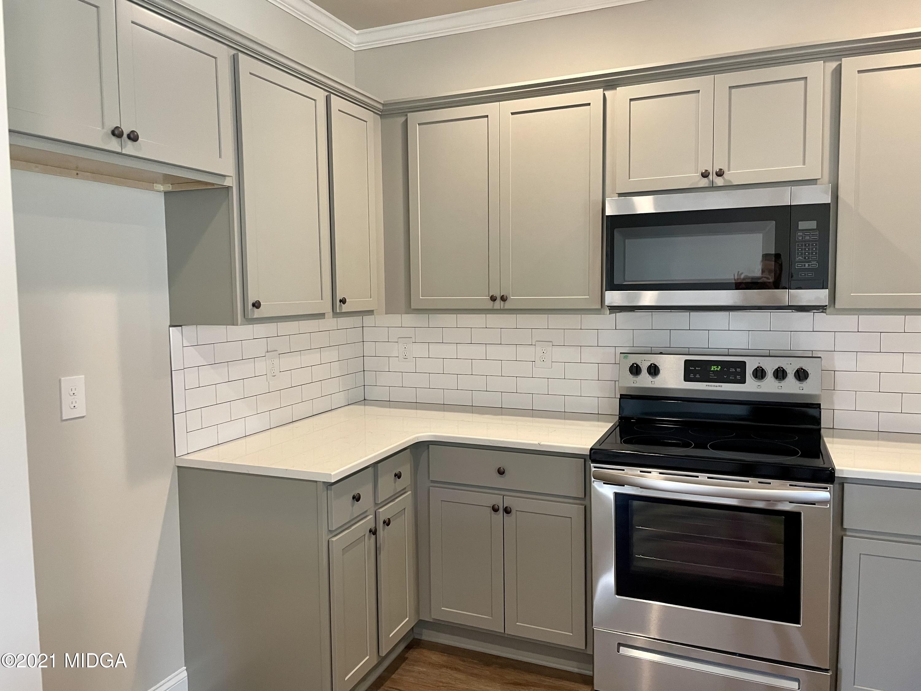 1452 Bunn Road Forsyth, GA 31029 - Photo 4 of 9 a kitchen with cabinets stainless steel appliances and a sink