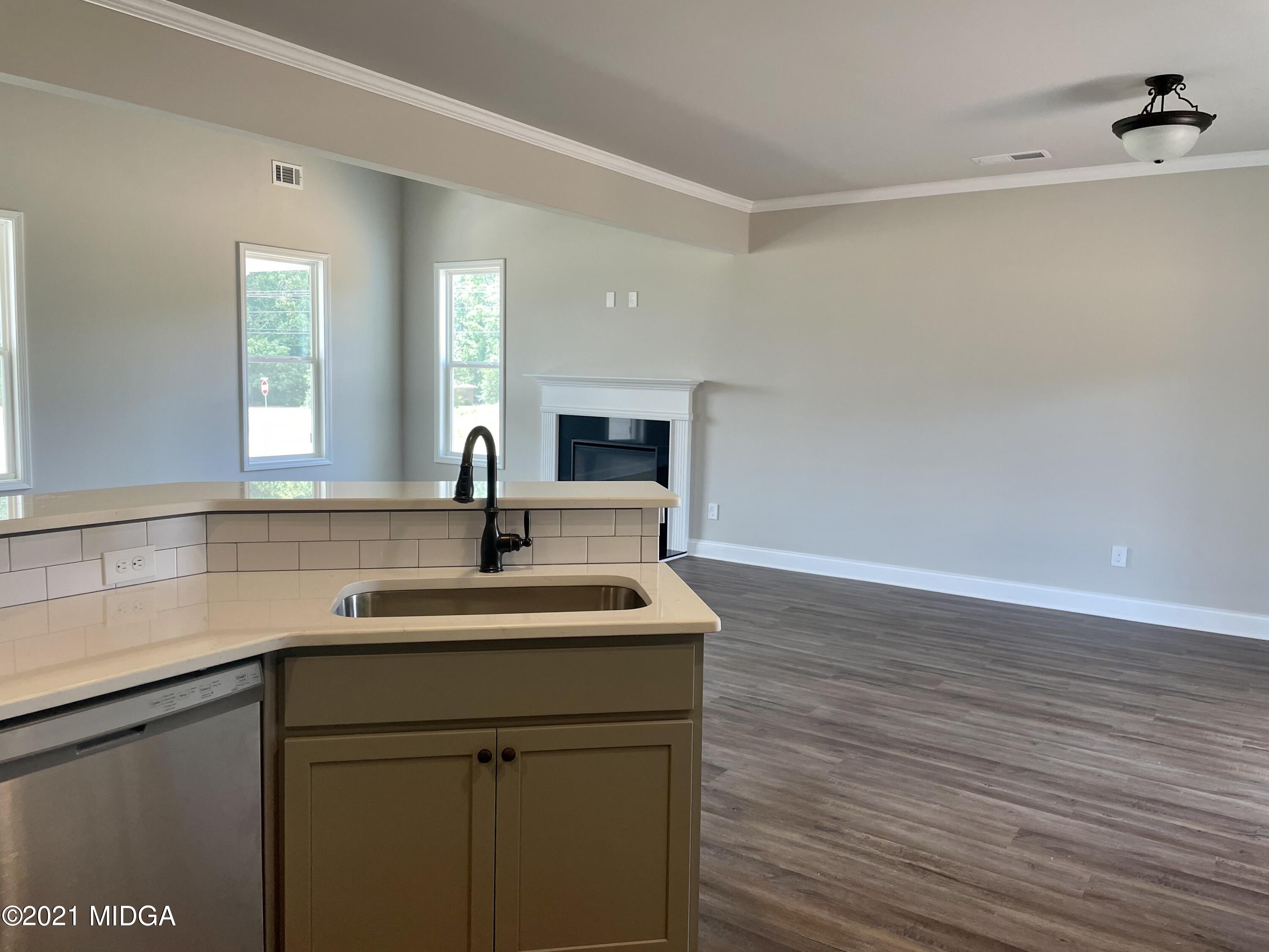 1452 Bunn Road Forsyth, GA 31029 - Photo 6 of 9 a kitchen with a sink cabinets and wooden floor