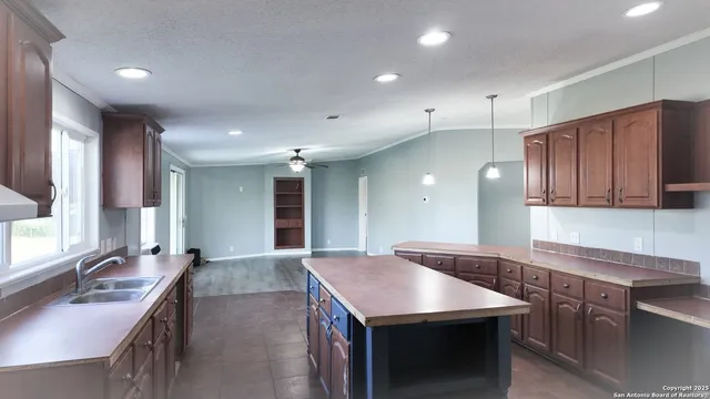 a kitchen with a stove a sink and a refrigerator