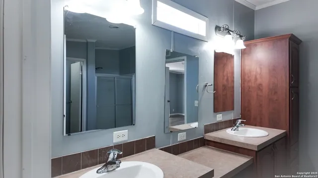 a bathroom with a sink and a mirror