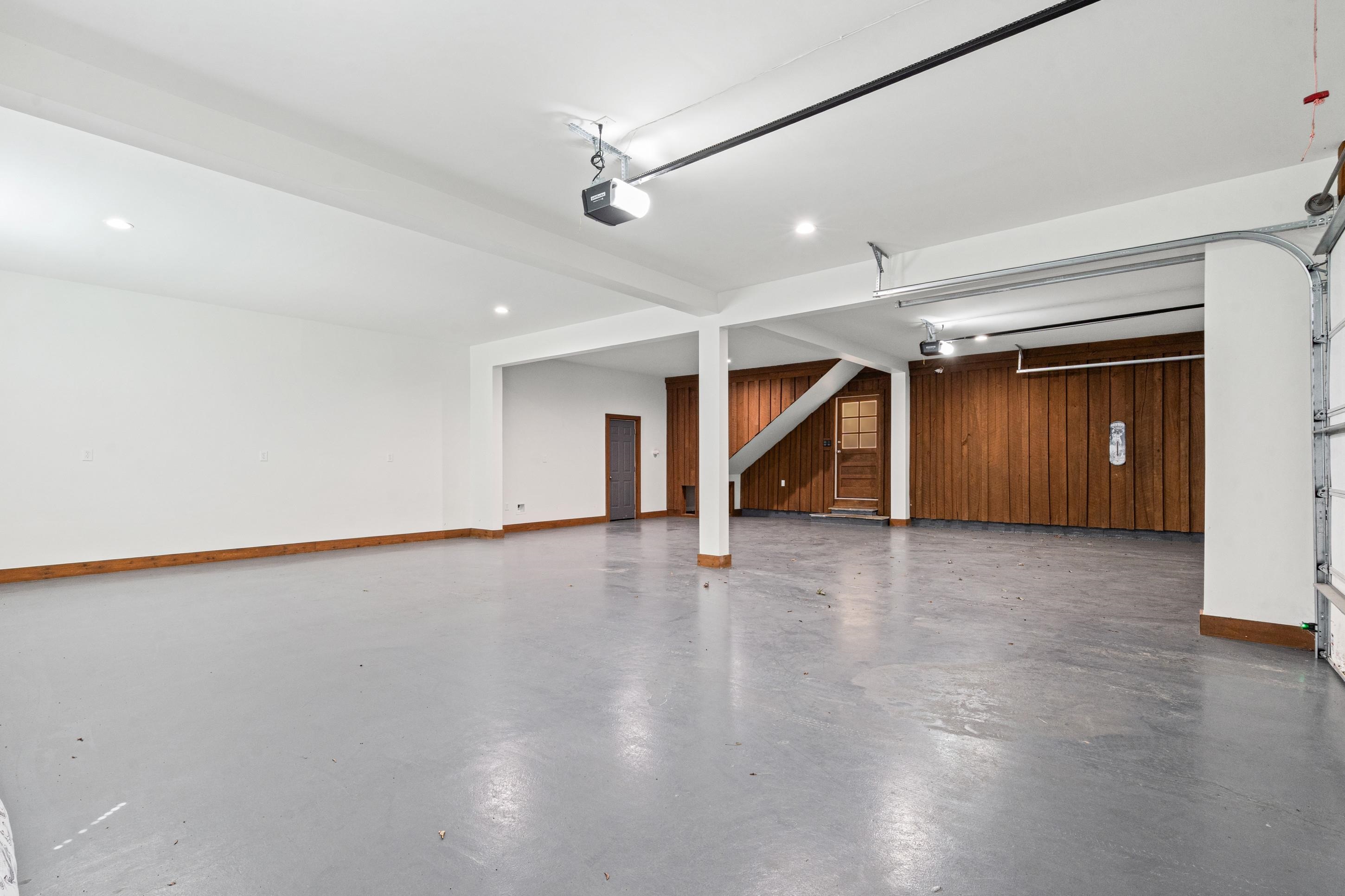 620 Diffee Road Moscow, TN 38057 - Photo 19 of 25 Spacious garage featuring recessed lighting, epoxy concrete floor, wood-paneled walls from the original siding on the house, with a door into the morning room