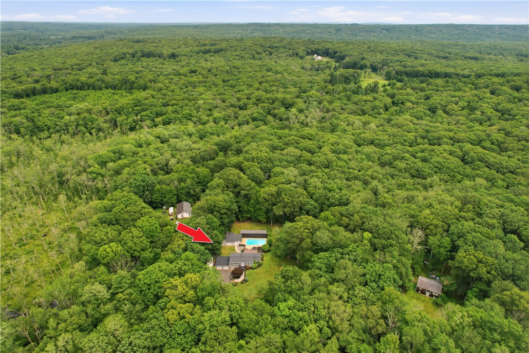 214 Anan Wade Road Glocester, RI 02857 - Photo 7 of 50 So much more than meets the eye from the street—the property unfolds into a remarkable private retreat with extensive outdoor amenities and room to roam.