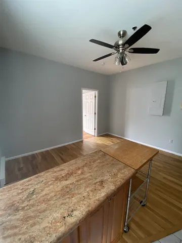 a view of a room with a ceiling fan