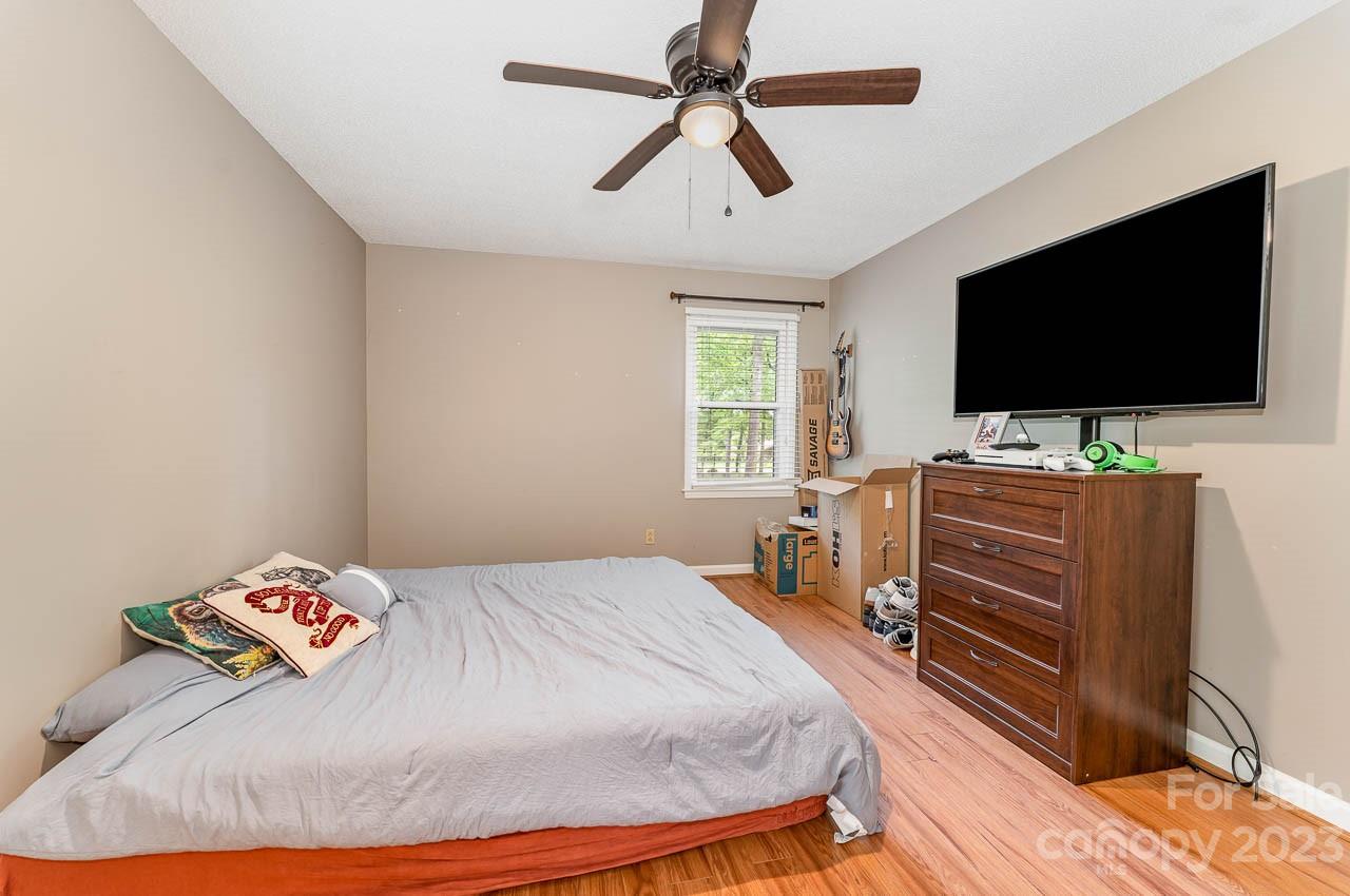 240 Hidden Hut Road Salisbury, NC 28147 - Photo 20 of 32 a bedroom with a bed and a flat screen tv