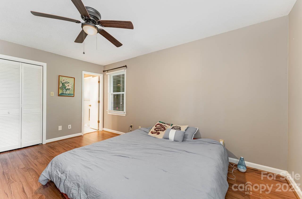 240 Hidden Hut Road Salisbury, NC 28147 - Photo 21 of 32 a bedroom with a bed and a chandelier