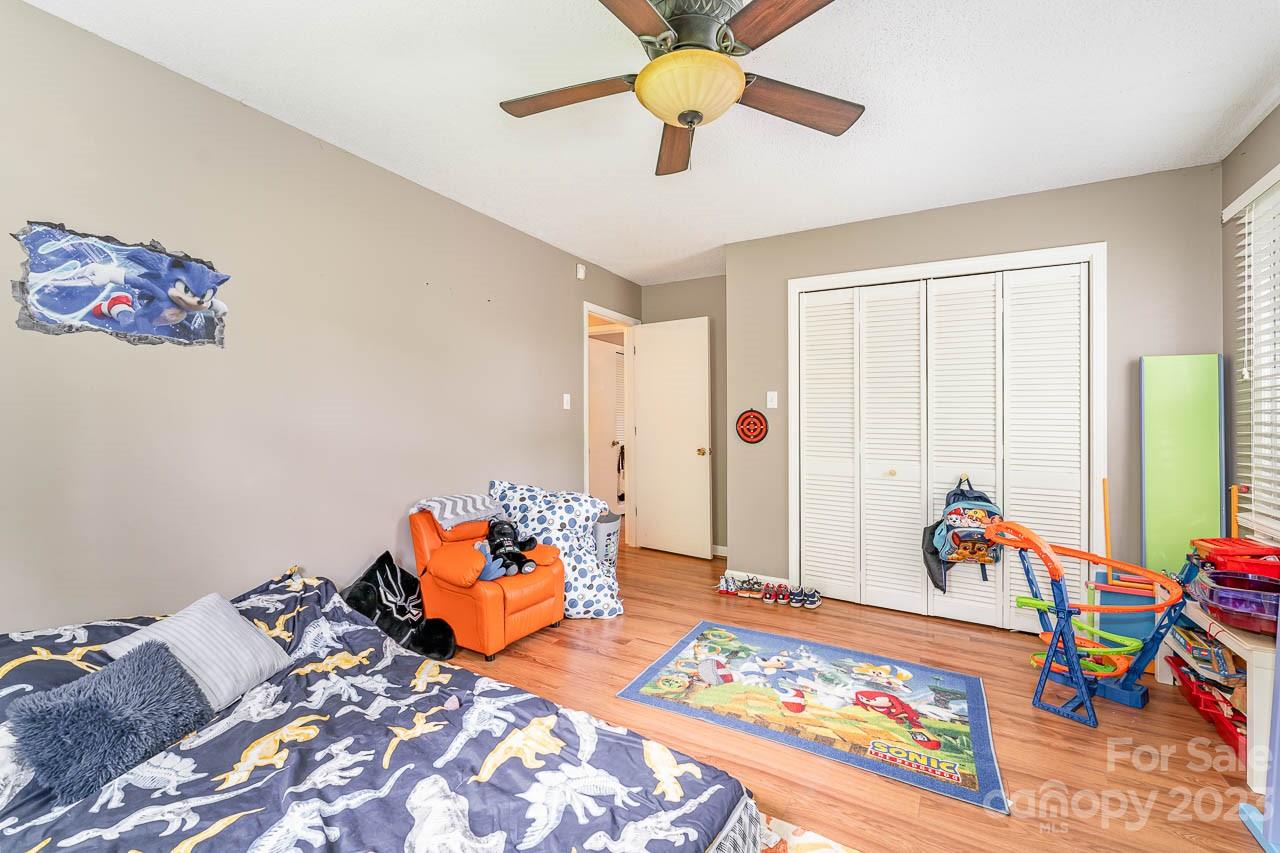 240 Hidden Hut Road Salisbury, NC 28147 - Photo 27 of 32 a bed room with furniture and a chandelier