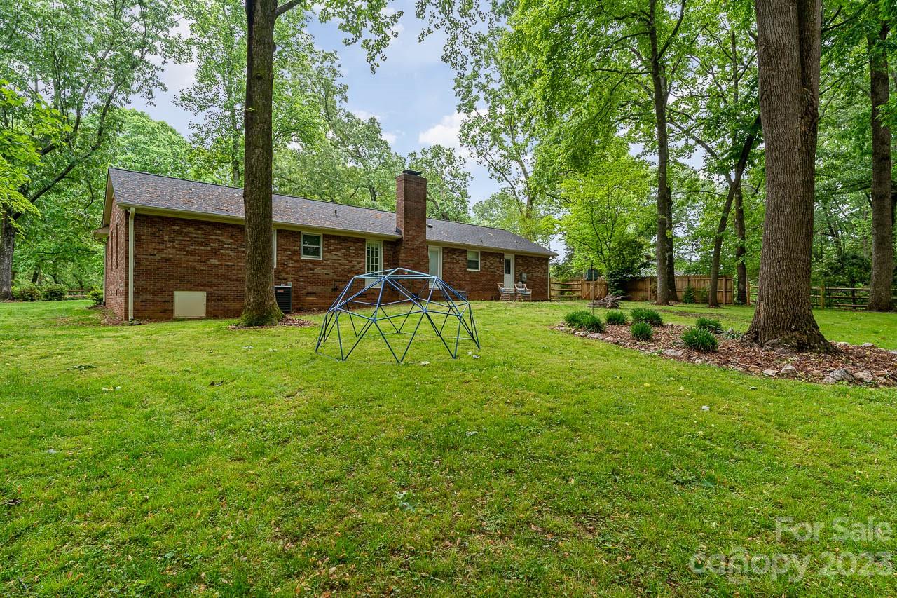 240 Hidden Hut Road Salisbury, NC 28147 - Photo 29 of 32 a view of a backyard with a garden and trees