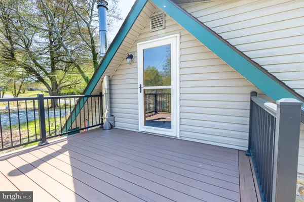 a view of a house with wooden deck