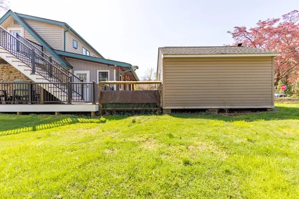 a view of a house with a backyard