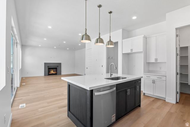 36 South Crimson Way, Unit 305 Mapleton, UT 84664 - Photo 4 of 7 Modern kitchen island with a built-in sink, stainless steel faucet, and pendant lighting