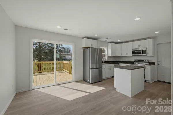 a kitchen with stainless steel appliances granite countertop a refrigerator sink and microwave