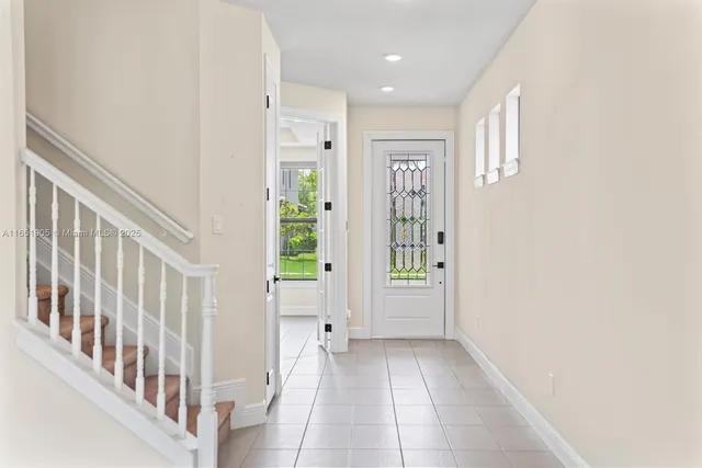 a view of an entryway with wooden floor and windows