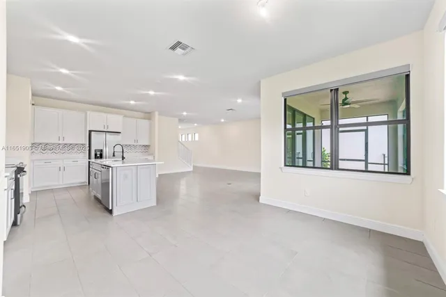 a view of kitchen with white cabinets