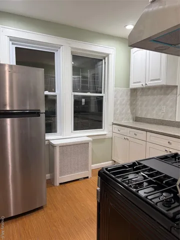 a kitchen with granite countertop a stove and a refrigerator