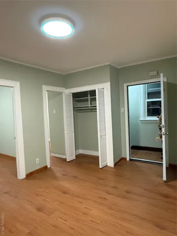 an empty room with closet and a window