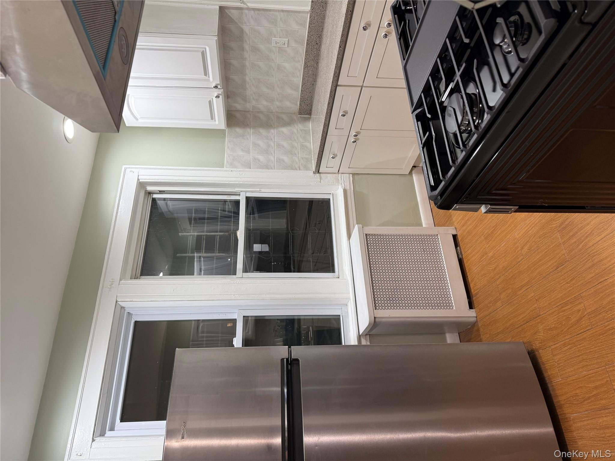 127-05 88th Avenue Queens, NY 11418 - Photo 9 of 9 a kitchen with granite countertop a stove and a refrigerator