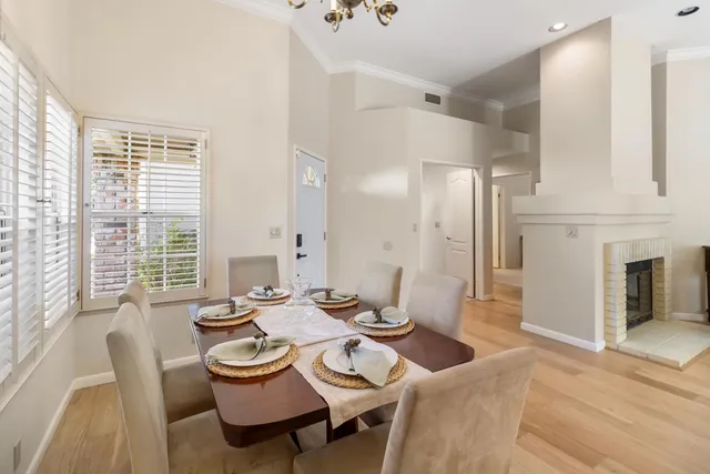 a kitchen with a sink a counter top space stainless steel appliances a large window and cabinets