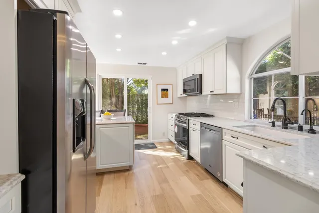 a kitchen with a sink appliances and cabinets