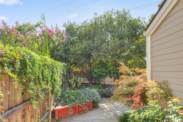 a view of a house with a yard and a street