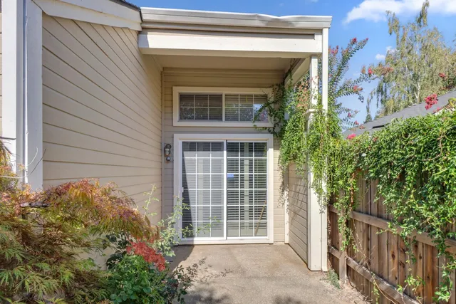 an aerial view of a house with swimming pool and large trees