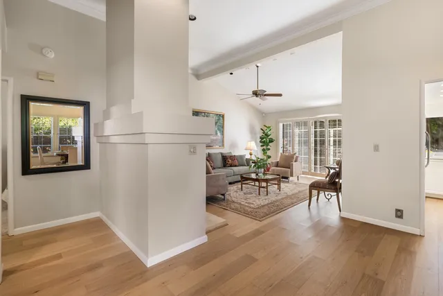 a living room with furniture a fireplace and a table