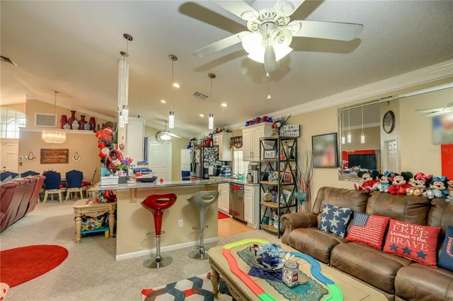 a living room filled with furniture and a chandelier