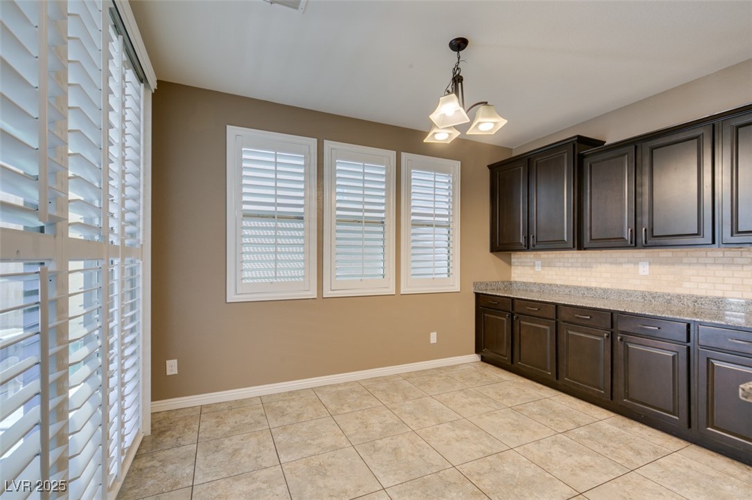11063 Mt George Street Las Vegas, NV 89179 - Photo 14 of 49 Kitchen featuring decorative backsplash, dark brow