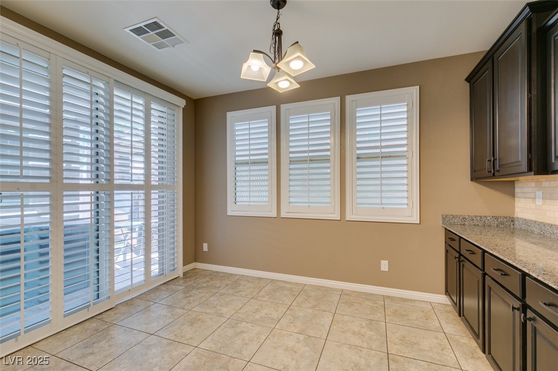 11063 Mt George Street Las Vegas, NV 89179 - Photo 15 of 49 Unfurnished dining area with a chandelier and ligh