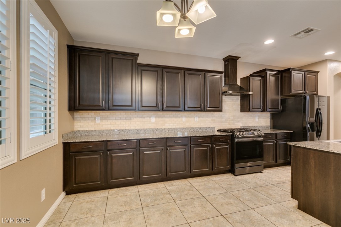 11063 Mt George Street Las Vegas, NV 89179 - Photo 16 of 49 Kitchen with gas stove, tasteful backsplash, wall