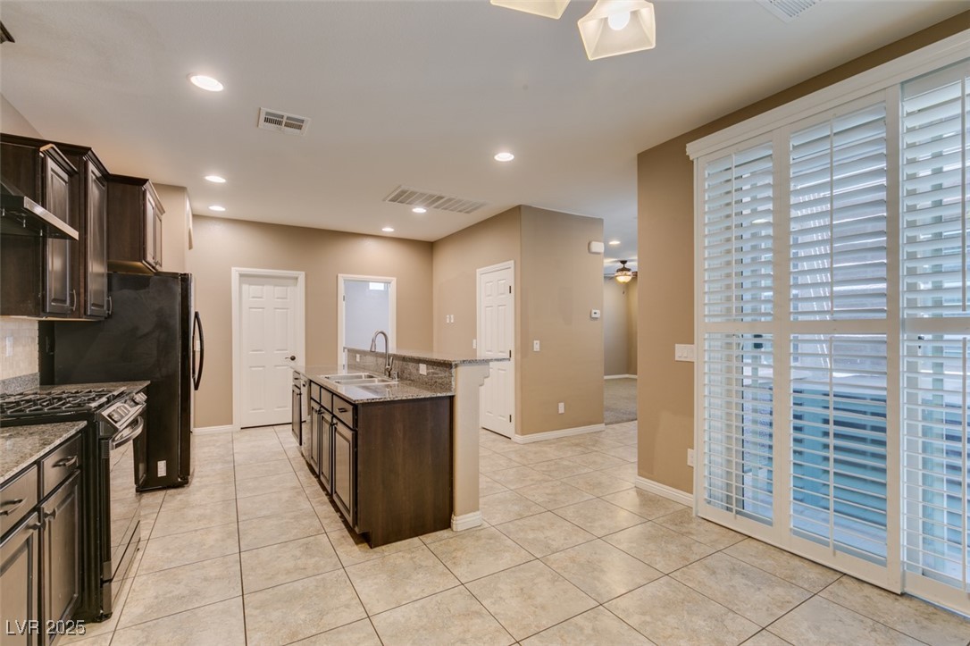 11063 Mt George Street Las Vegas, NV 89179 - Photo 19 of 49 Kitchen featuring stainless steel range with gas c