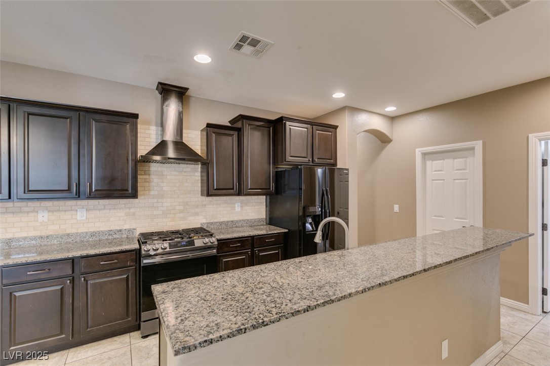 11063 Mt George Street Las Vegas, NV 89179 - Photo 22 of 49 Kitchen featuring gas stove, wall chimney range ho