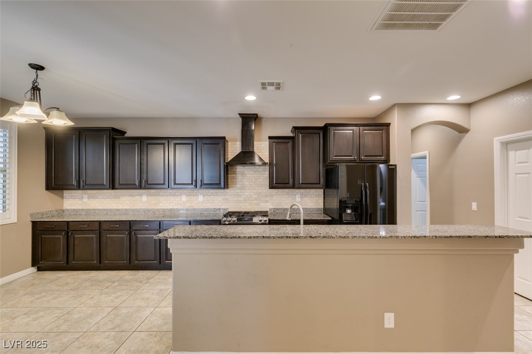 11063 Mt George Street Las Vegas, NV 89179 - Photo 23 of 49 Kitchen featuring light tile patterned floors, bac