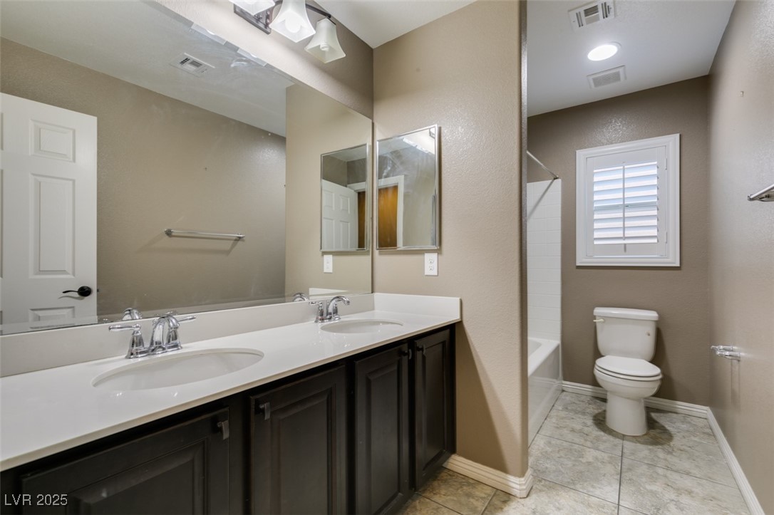 11063 Mt George Street Las Vegas, NV 89179 - Photo 36 of 49 Full bathroom featuring double vanity, tile patter