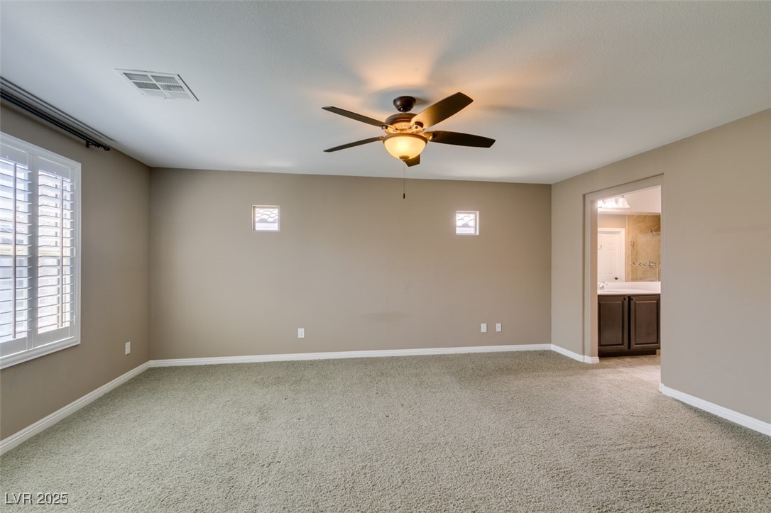 11063 Mt George Street Las Vegas, NV 89179 - Photo 37 of 49 Empty room featuring light carpet and ceiling fan