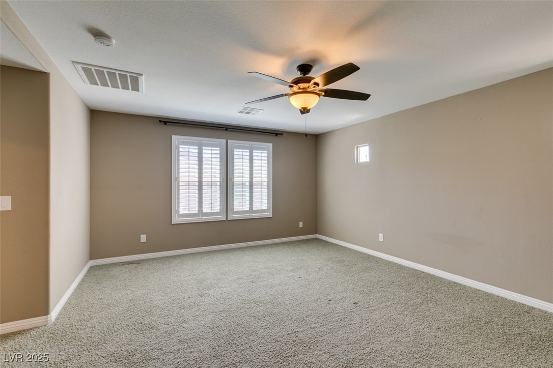 11063 Mt George Street Las Vegas, NV 89179 - Photo 38 of 49 Carpeted spare room with ceiling fan and a smoke d